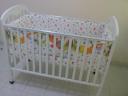 white wooden baby cot